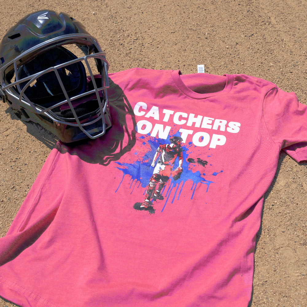 A baseball catcher mask and shirt that says "Catchers on Top" with a silhouette of a baseball catcher.