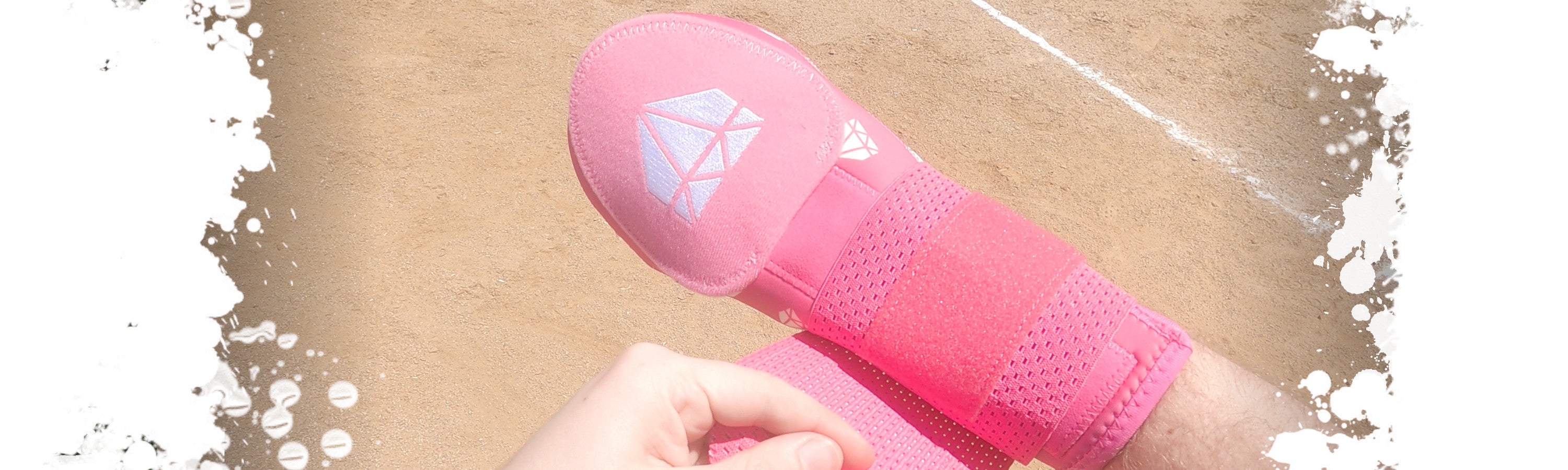 A baseball player adjusting the elastic Velcro strap on the Pimp Job Pink teen sized baseball sliding mitt from Web Gem Apparel.
