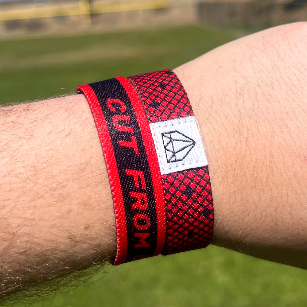 Baseball player wrist photo of Cut from Courage wristband showcasing double sided design.