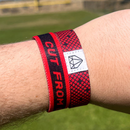 Baseball player wrist photo of Cut from Courage wristband showcasing double sided design.