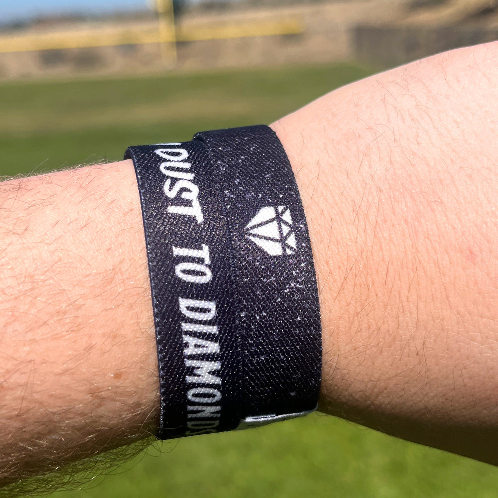 Baseball player wrist photo of From Dust to Diamonds wristband showcasing double sided design