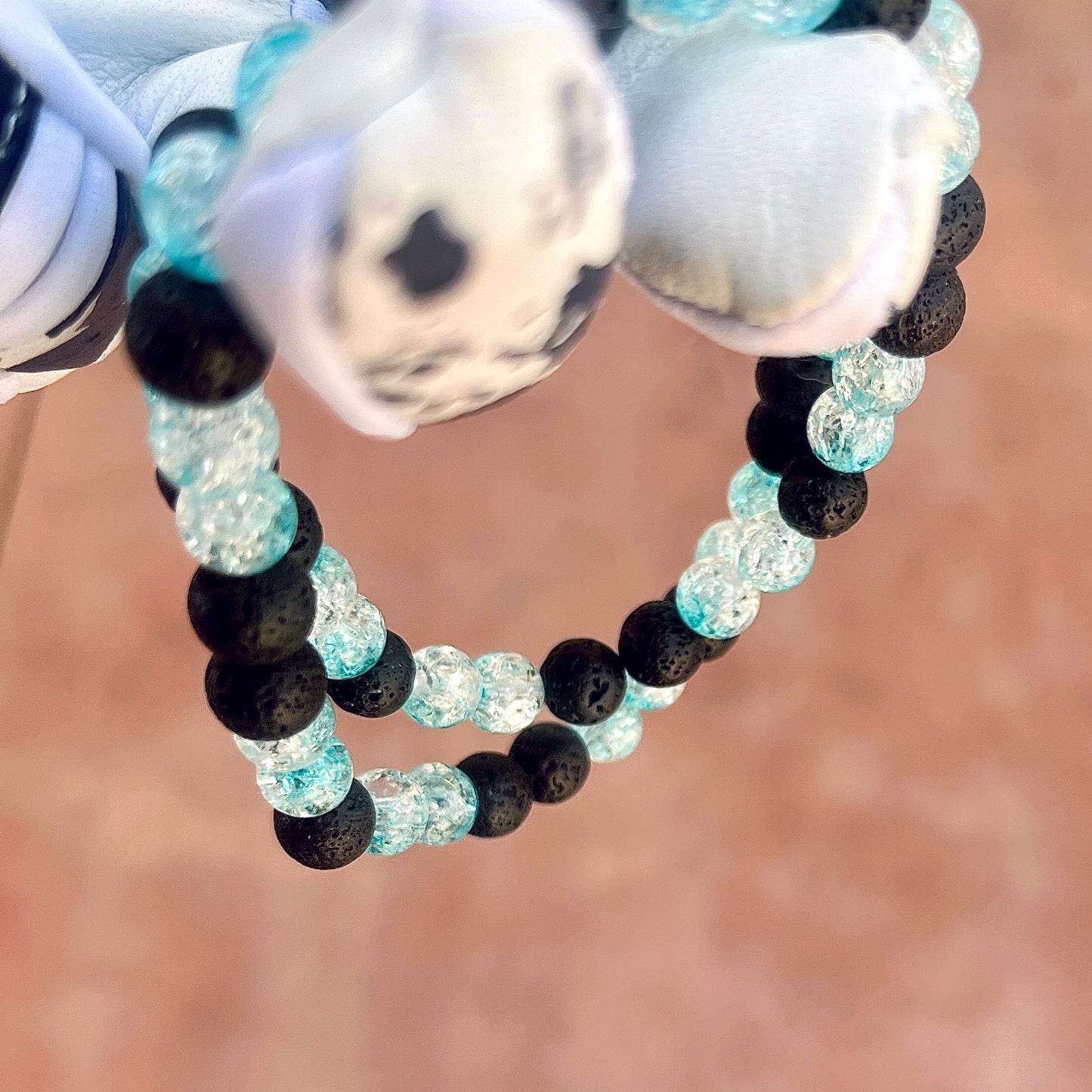 Glamour shot of Frozen Rope Necklace featuring real black lava rocks and baby blue ice beads.