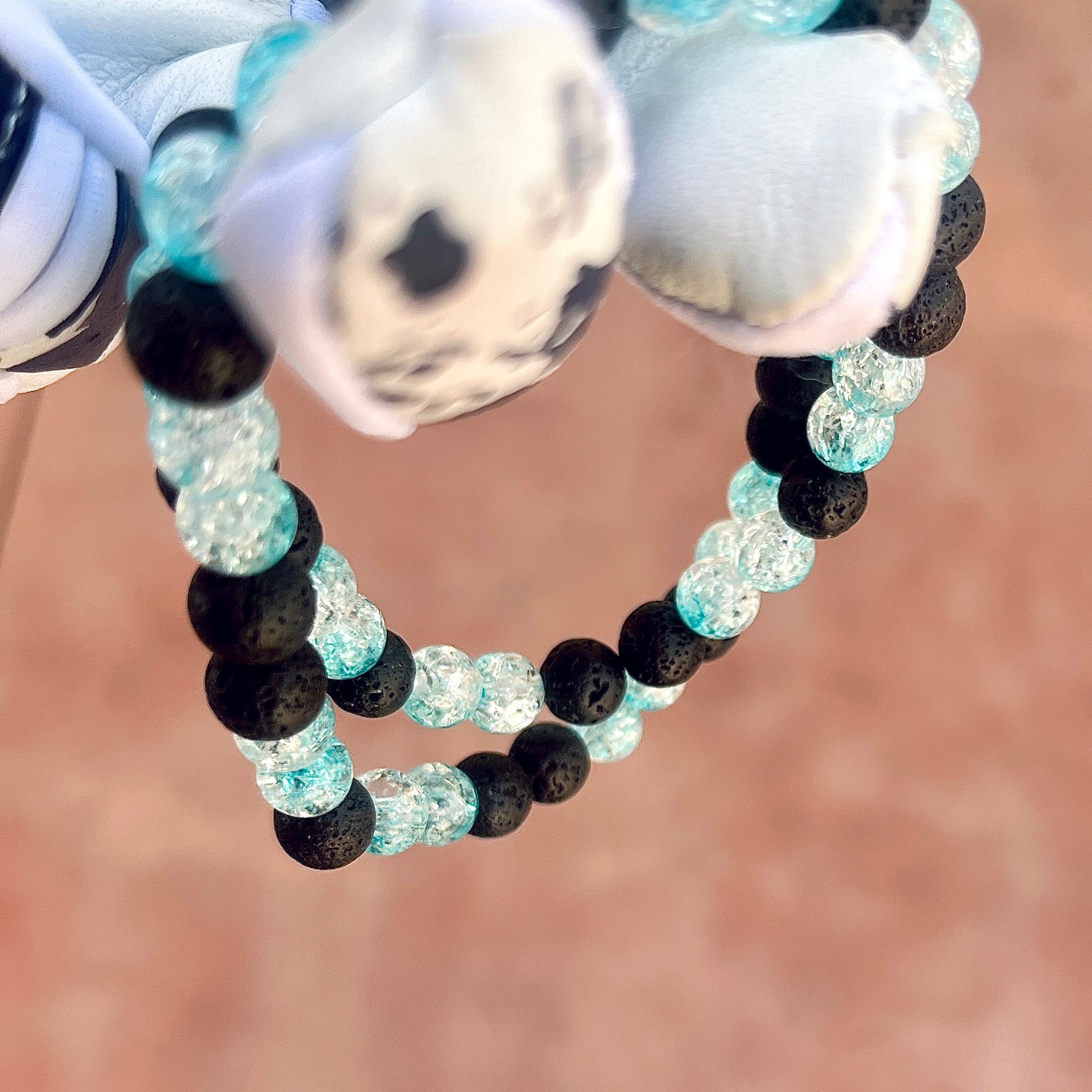 Glamour shot of Frozen Rope Necklace featuring real black lava rocks and baby blue ice beads.