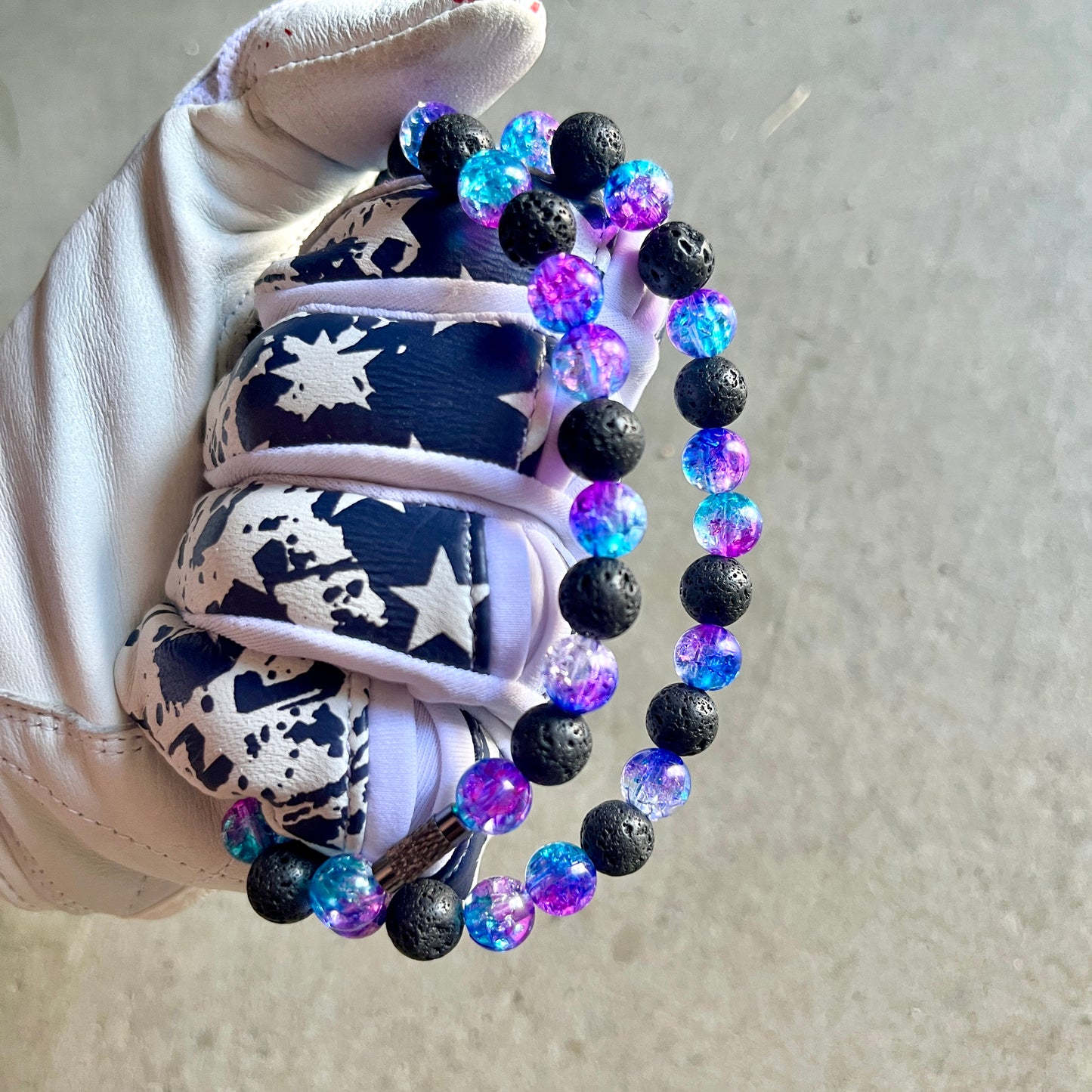 Glamour shot of Galaxy Necklace featuring real black lava rocks and nebula ice beads.