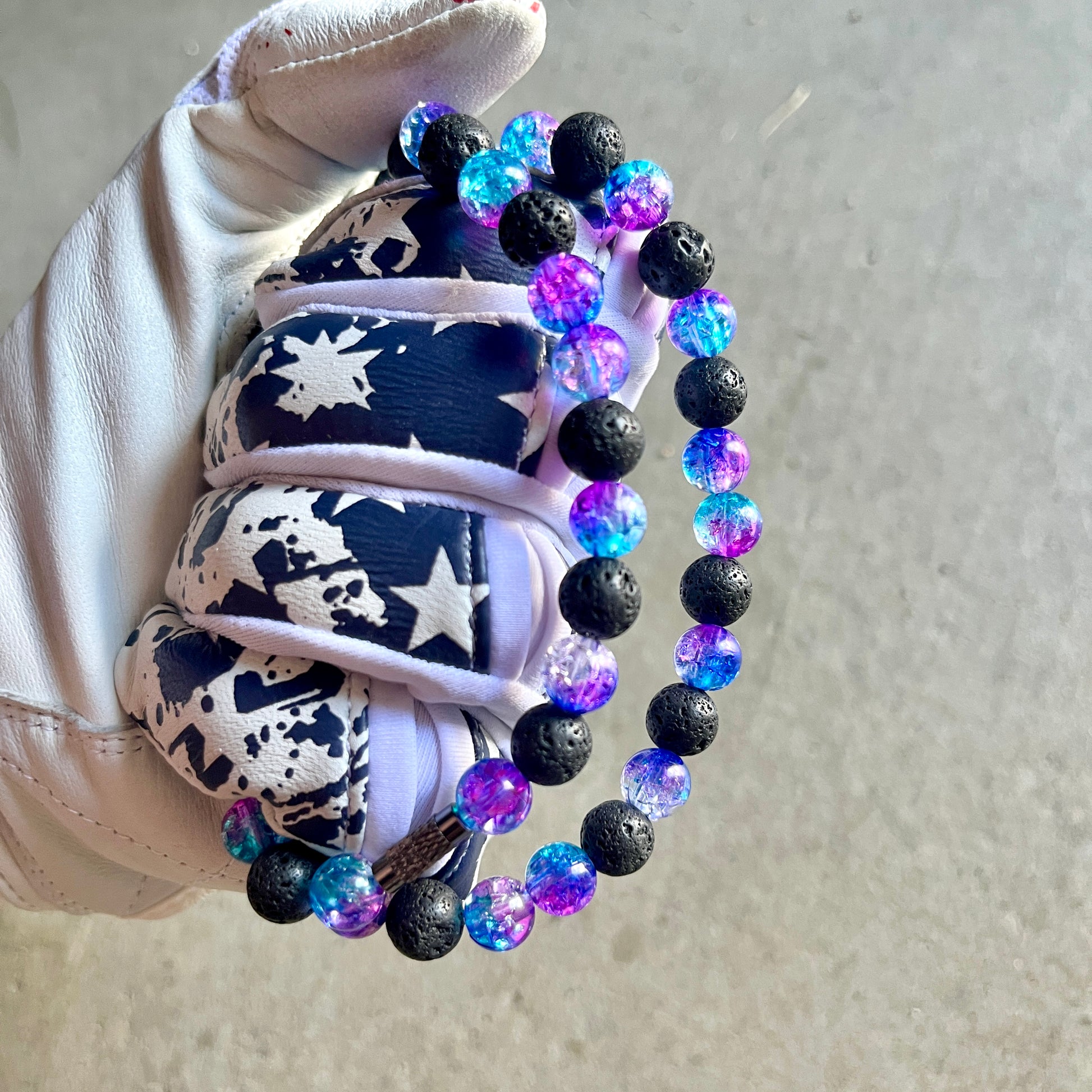 Glamour shot of Galaxy Necklace featuring real black lava rocks and nebula ice beads.