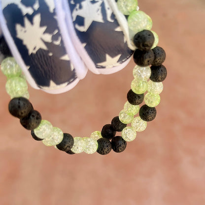 Glamour shot of Gas Gas Gas Necklace featuring real black lava rocks and lime ice beads.