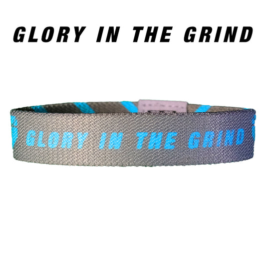 Glory in the Grind Baseball outer design with blue text on a silver elastic wristband.
