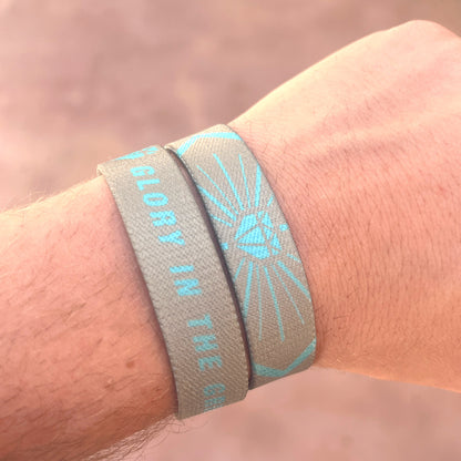 Baseball player wrist photo of Glory in the Grind wristband showcasing double sided design.