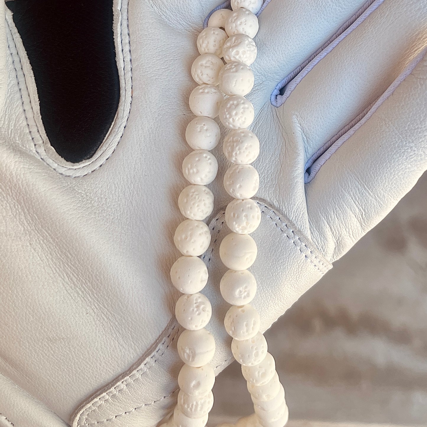 Glamour shot of Moonshot Necklace featuring real white lava rocks.