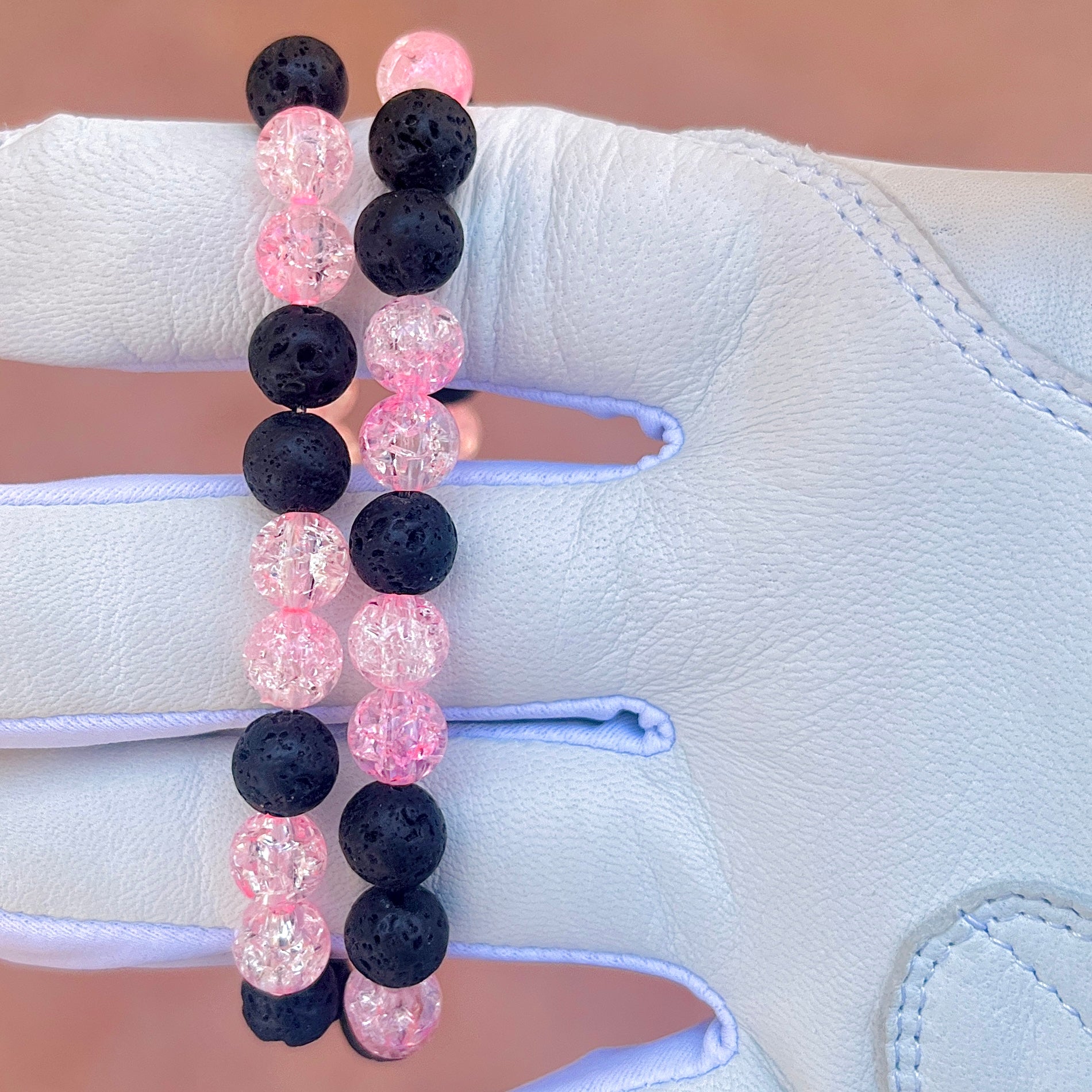 Glamour shot of Pink Bomb Necklace featuring real black lava rocks and pink ice beads.