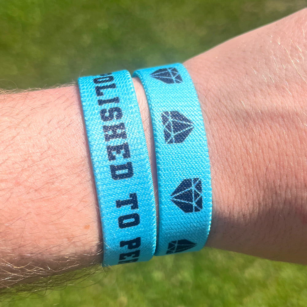 Baseball player wrist photo of Polished to Perform wristband showcasing double sided design.