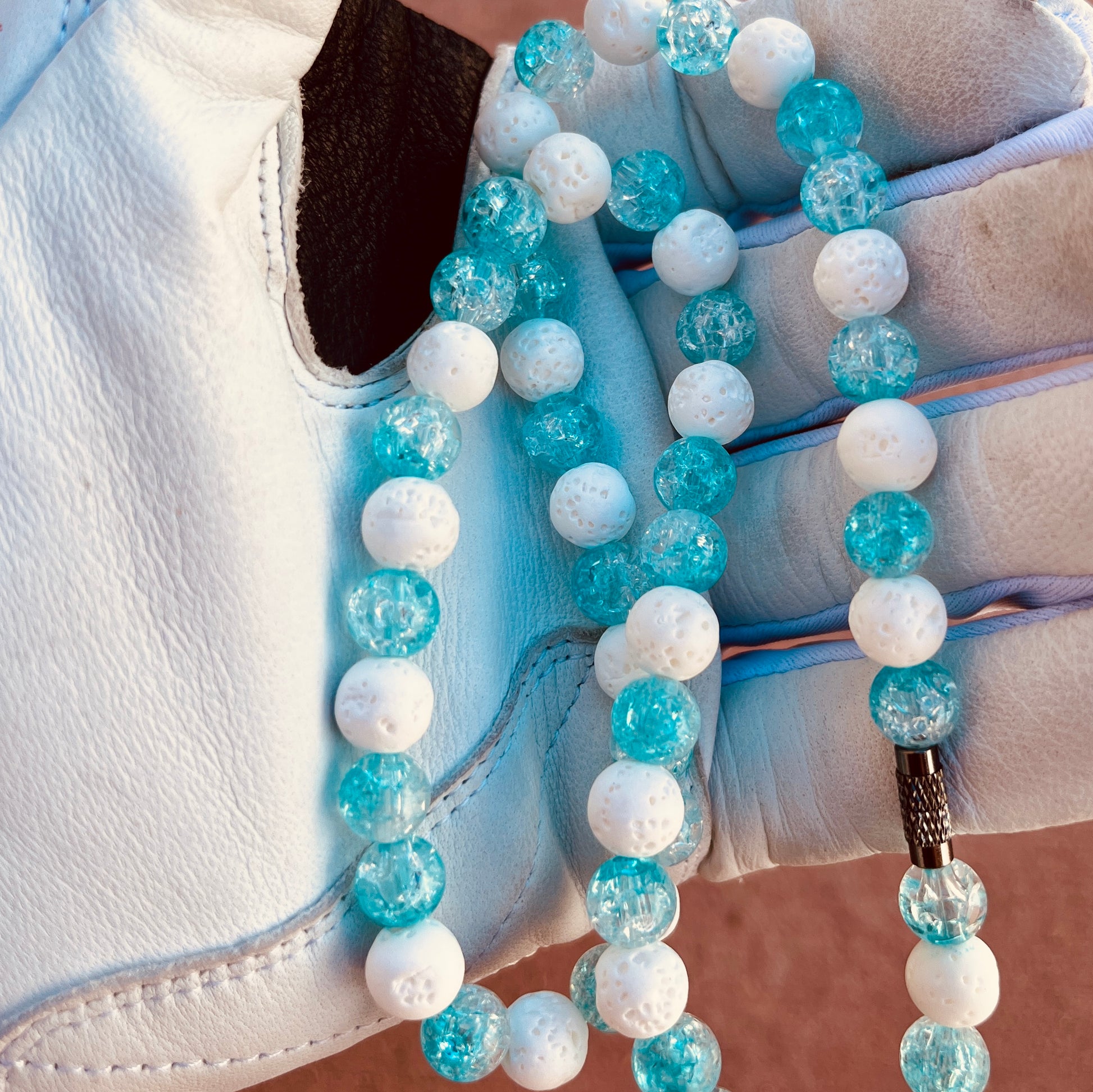 Glamour shot of Snowball Necklace featuring real white lava rocks and blue ice beads.